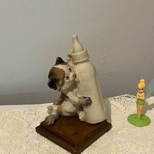 Cat Figurine with Baby Bottle sitting on wood mantel.